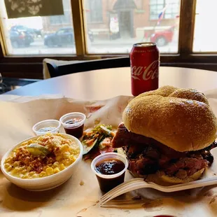 This is the MVP 15 sandwich (brisket, sausage, pulled pork and topped with burnt ends) and a side of smoked elotes.