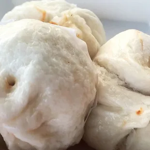 a close up of a plate of steamed buns