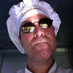 a man wearing a hat and sunglasses