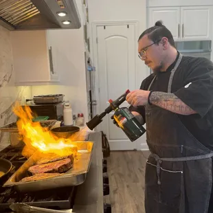 Torch searing Australian waygu New York strips