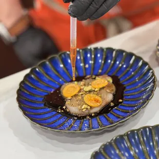 Homemade blood orange and lemongrass ponzu, imported Japanese hamachi, gooseberries, pistachio, Calabrian chili oil