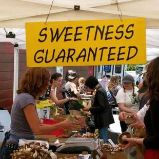 a group of people at a farmers market