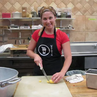 a woman in a kitchen preparing food