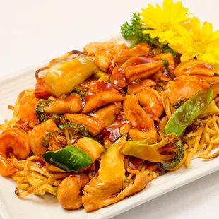 a plate of chinese food with noodles and broccoli