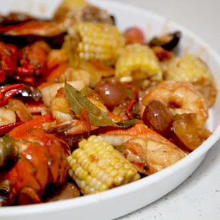a bowl of seafood and corn