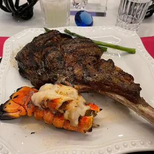 Tomahawk chop w/ butter lobster tail abs asparagus.