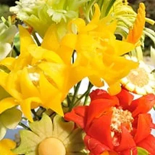 Red and Yellow Bell Pepper Flowers with Leek Mums, Cantaloupe and Orange Daisies