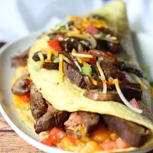 Fluffy Paleo friendly omelet with steak, onions tomatoes - so yum! mushrooms