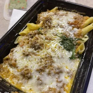 Penne pasta with creamy tomato &amp; meat sauce topped w/ cheese