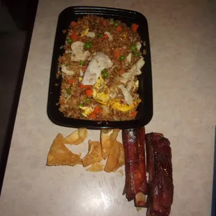 a plate of fried rice and bacon