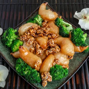 WALNUT CHICKEN: A tasty blend of breaded, fried shrimp with broccoli and a zesty walnut sauce.