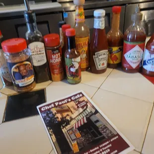 A bunch of seasonings and hot sauces.