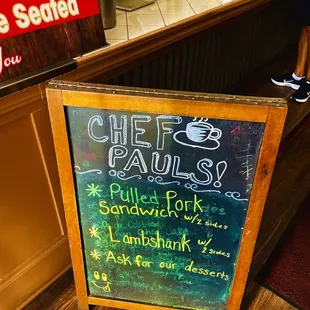 a chalkboard sign in front of the counter