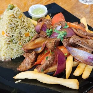 Lomo saltado with cilantro rice. Delicious!!!
