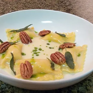 Sweet potato agnolotti with pecans, basil oil, and sage beurre blanc