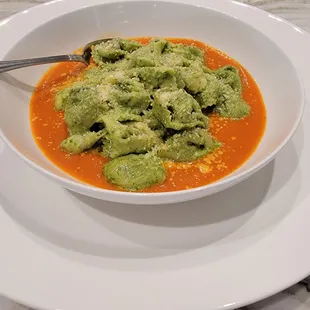 Spinach ricotta ravioli with pesto, and tomato sauce