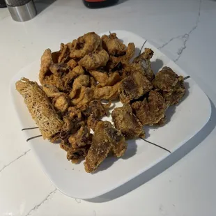 chicken skewers on a white plate