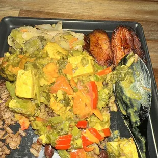 My plate of cabbage, tofu and callaloo, sweet plantains and rice and beans