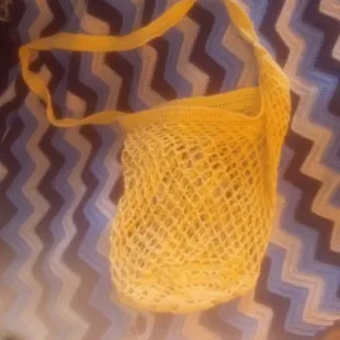 a yellow net bag on a table