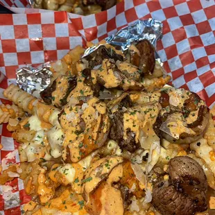 Surf N Turf Fries with premium cheese sauce and chipotle drizzle