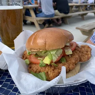 a chicken sandwich with lettuce, tomato, and lettuce