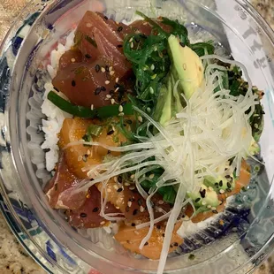 Fresh mixed poke bowl with rice n seaweed salad
