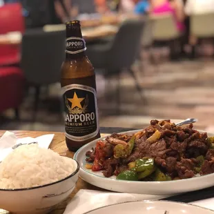 a plate of food and a bottle of beer