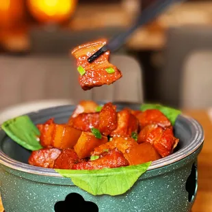 a bowl of food with chopsticks