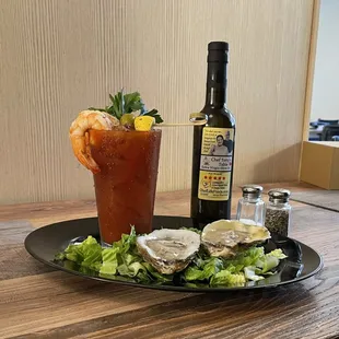 a plate of oysters and a bottle of wine