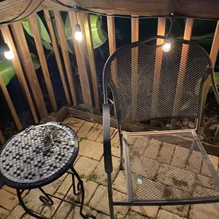 a patio with a table and chairs