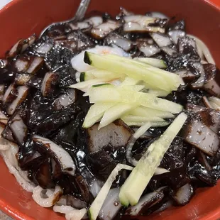 a bowl of noodles with meat and vegetables