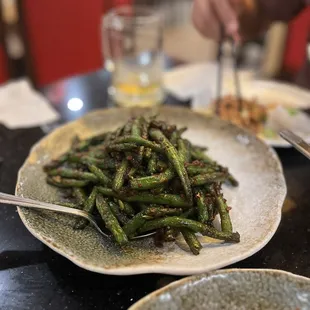 a plate of stir fried green beans