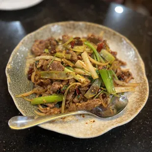 a plate of food with meat and vegetables