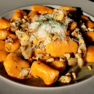 a plate of carrots with parmesan and walnuts
