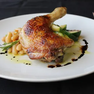 Oven roasted, all natural chicken leg and thigh served with soft cannellini bea