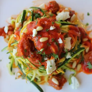 Shaved zucchini and yellow squash "pasta," with goat cheese, pine nuts, house-made Italian sausage, and red pepper sauce