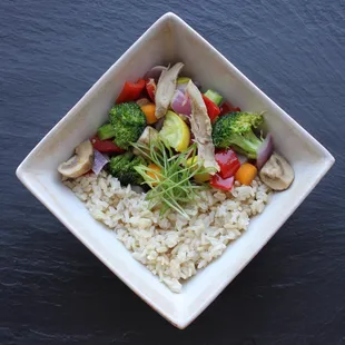 Kids stir fry: a colorful mix of fresh market vegetables and chicken with a sweet soy glaze, served over brown rice