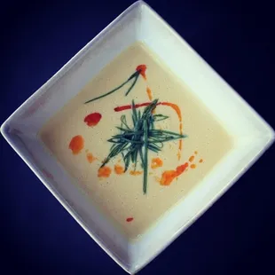 Fresh sweet summer corn blended with light coconut infused with galangal, kafir lime and lemon grass flavors, and finished with spicy oil