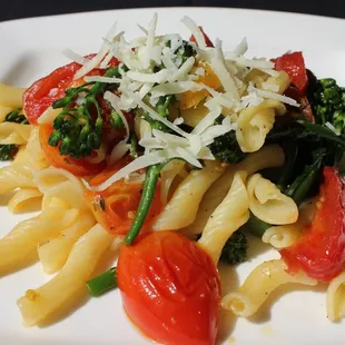 Trochee pasta tossed with extra virgin olive oil, blistered baby heirloom tomatoes, rapini, garlic, and fresh grated pecorino romano cheese