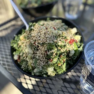 a bowl of salad and a glass of water