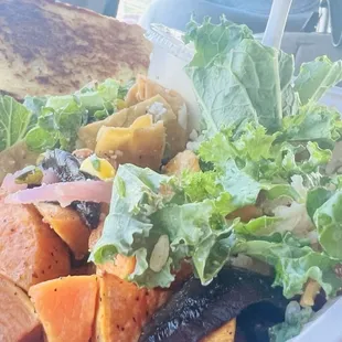 a salad in a styrofoam container