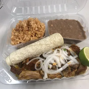 Cochinta Pibil with some rice, beans, two warm tortillas, lime, and lemon soaked onions with some habanero peppers. DELICIOUS!!!