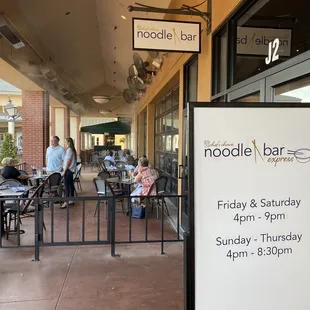 Outdoor patio and current hours.