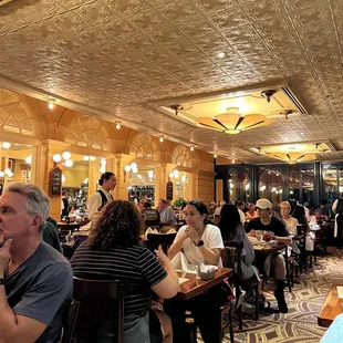 a crowded restaurant with people sitting at tables
