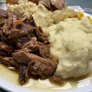 a plate of meat and mashed potatoes