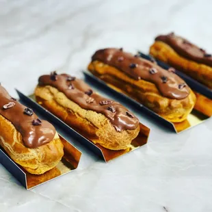 a row of chocolate covered hot dogs