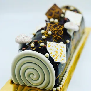 a chocolate roll cake on a gold plate