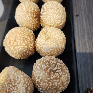 sesame balls on a black plate