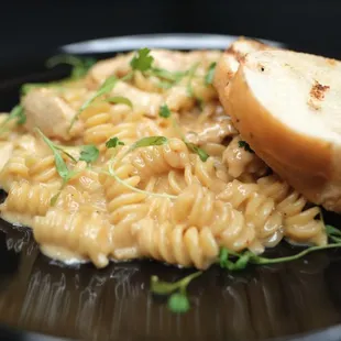 a plate of pasta and bread