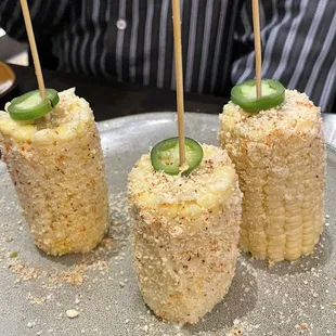 4 elotes on a stick. (One was taken already)